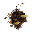 Spice mix including cardamom pods and cinnamon sticks on a white background